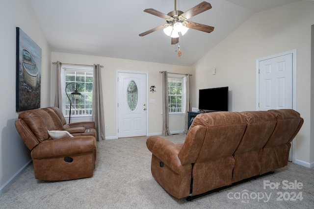 living room featuring a healthy amount of sunlight, ceiling fan, light colored carpet, and vaulted ceiling