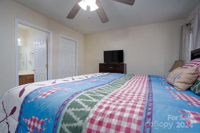 bedroom featuring a closet, ensuite bath, and ceiling fan