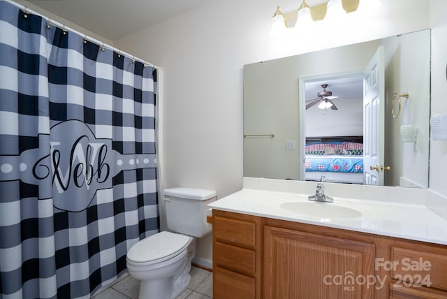 bathroom featuring tile patterned floors, vanity, toilet, and ceiling fan