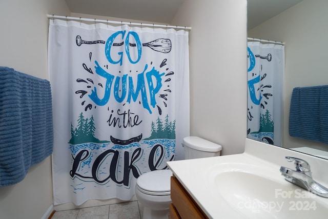 bathroom with tile patterned flooring, vanity, toilet, and curtained shower