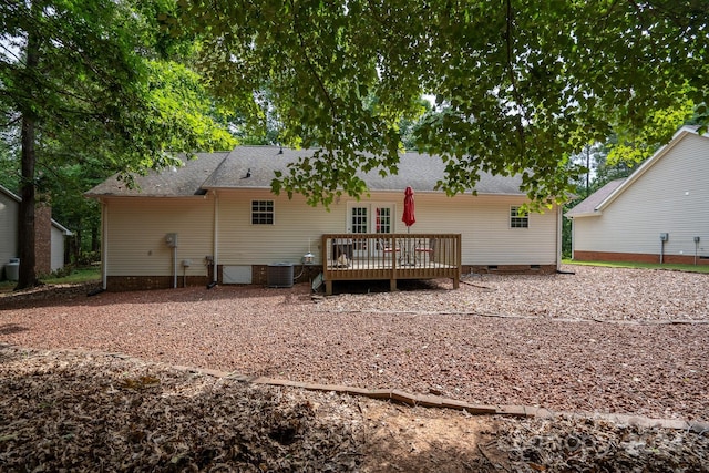 rear view of house featuring central AC and a wooden deck