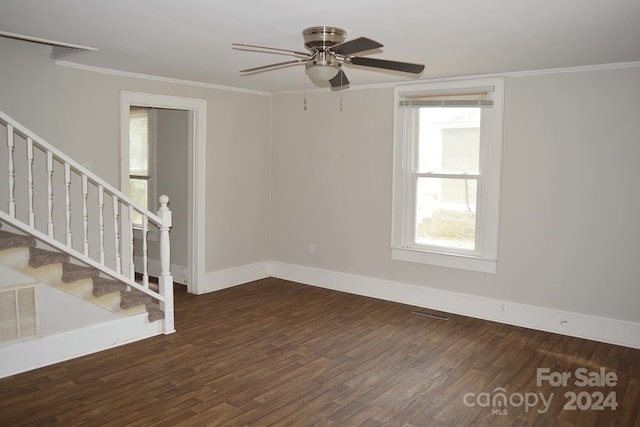 empty room featuring ceiling fan, dark hardwood / wood-style flooring, and ornamental molding