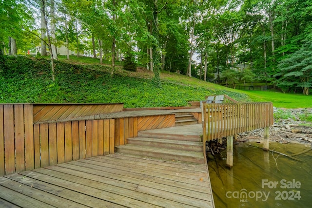 dock area featuring a deck and a yard