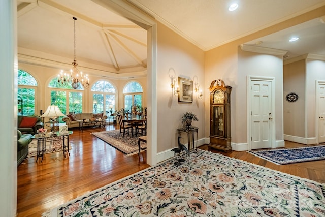 entryway with hardwood / wood-style flooring, a notable chandelier, and ornamental molding