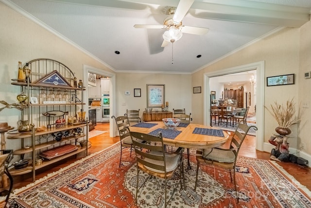 dining space featuring vaulted ceiling, light hardwood / wood-style flooring, ornamental molding, and ceiling fan