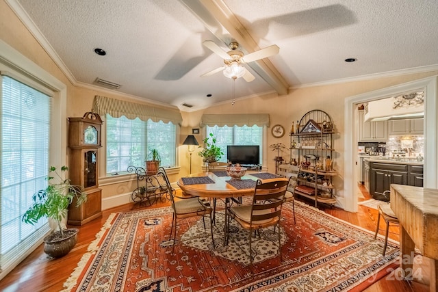 dining area with ceiling fan, wood-type flooring, ornamental molding, and plenty of natural light