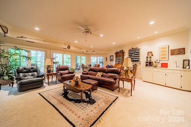 carpeted living room with crown molding, sink, and ceiling fan