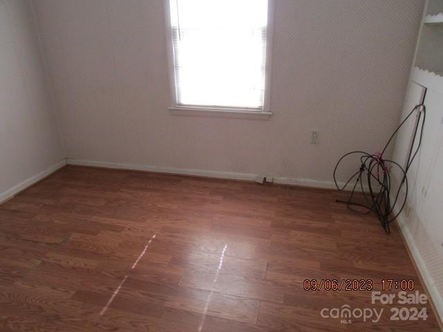 unfurnished room featuring dark hardwood / wood-style flooring