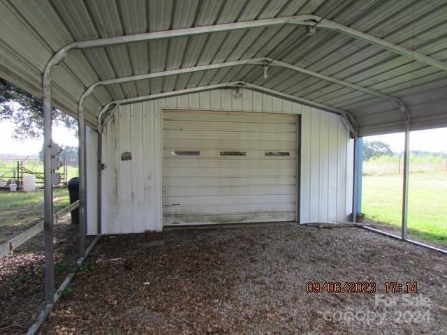 view of outdoor structure featuring a garage and a carport