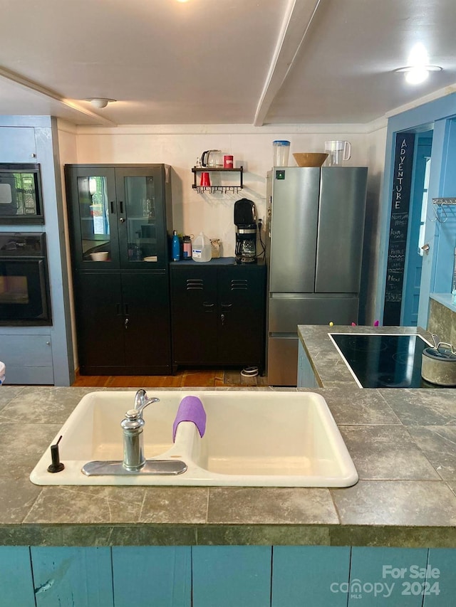 kitchen featuring sink and black appliances