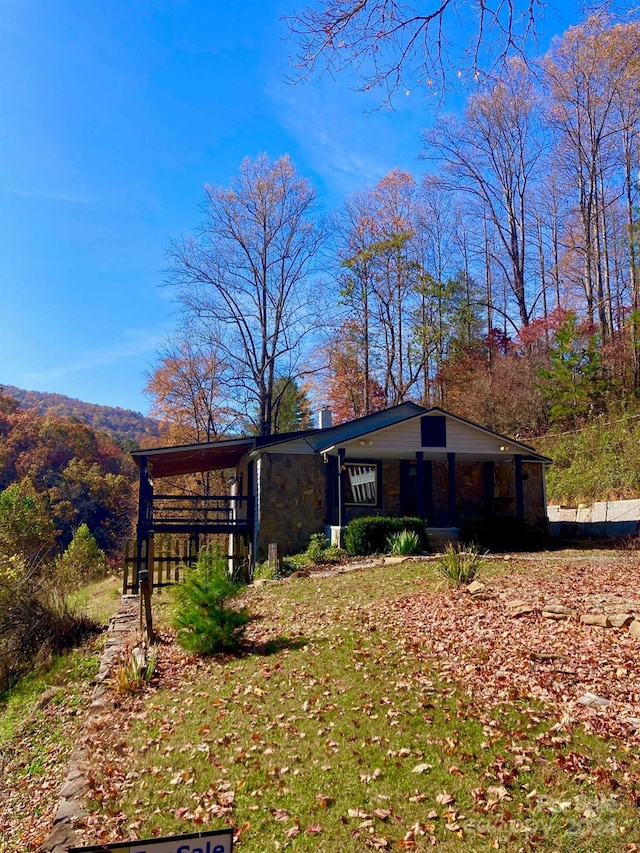 17 Moonlight Trl, Bryson City, NC 28713 - view of property exterior with stone siding, a porch, and a chimney