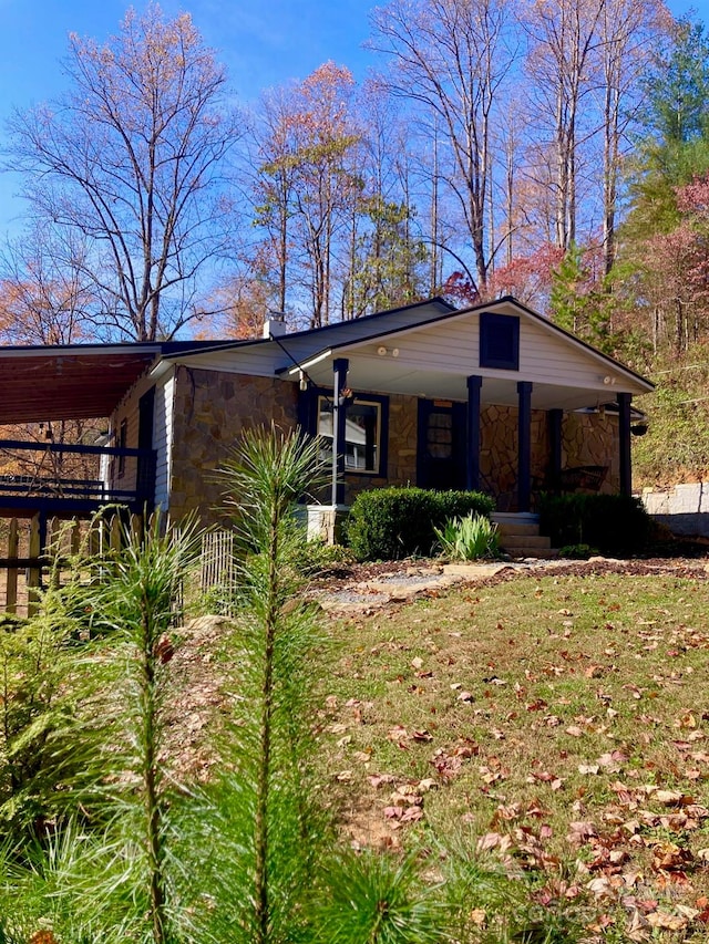 view of front of property with covered porch and a front yard