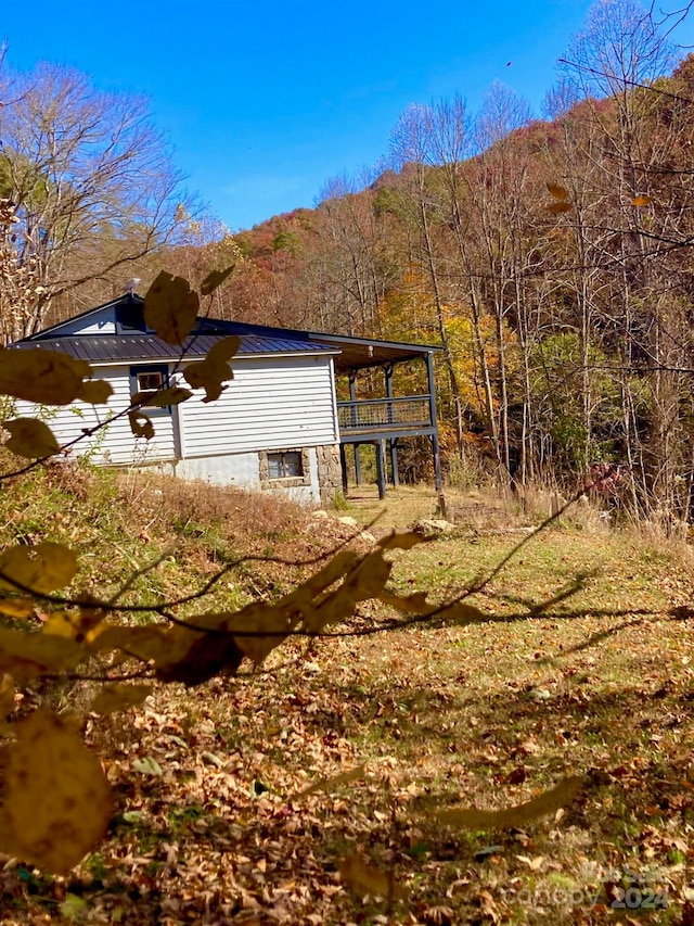 view of property exterior with a mountain view