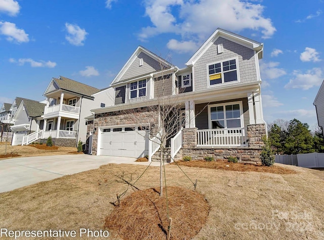 craftsman inspired home featuring a garage and a porch