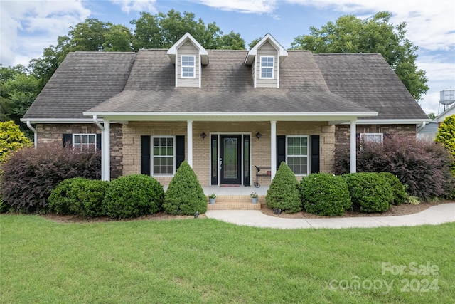 cape cod-style house with a front lawn