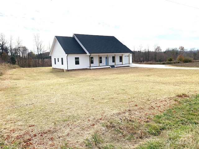 view of front of house with a porch and a front yard