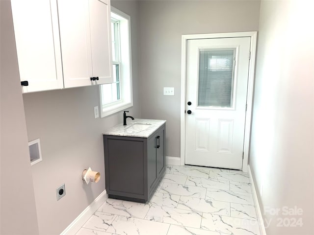 washroom featuring electric dryer hookup, cabinets, sink, and hookup for a washing machine