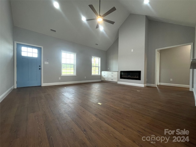 unfurnished living room with ceiling fan, dark hardwood / wood-style flooring, and high vaulted ceiling