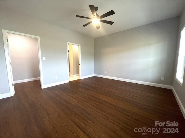 unfurnished bedroom with ceiling fan and dark hardwood / wood-style flooring