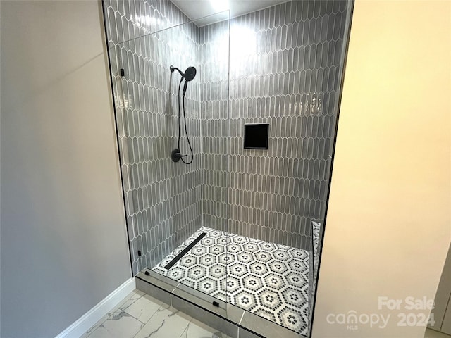 bathroom with a tile shower