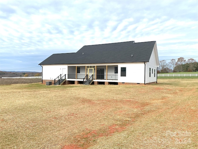 rear view of house with a lawn