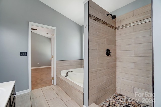 bathroom featuring vanity and plus walk in shower