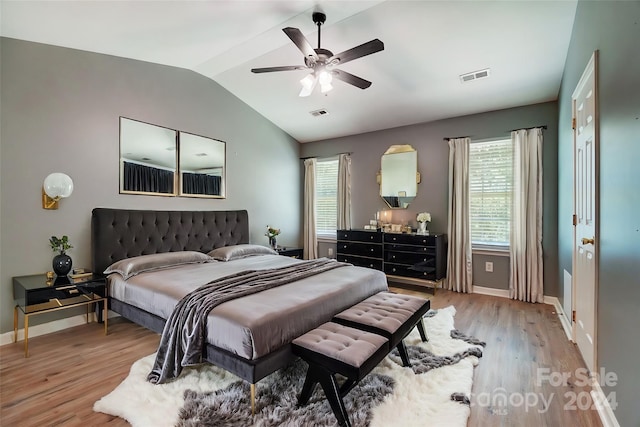 bedroom with ceiling fan, vaulted ceiling, and light hardwood / wood-style flooring