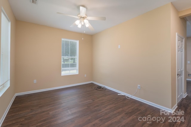 unfurnished room with ceiling fan and dark hardwood / wood-style flooring