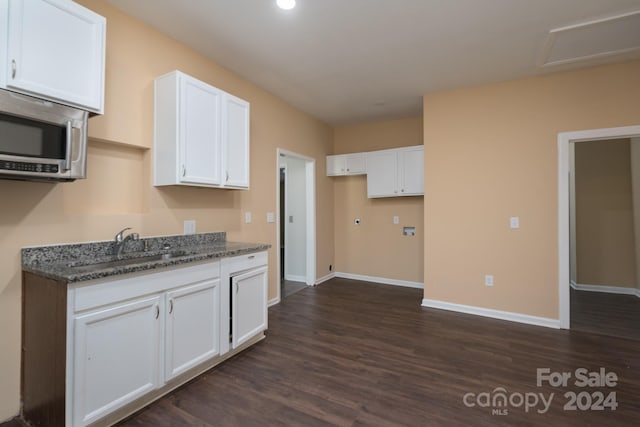 kitchen featuring sink, white cabinets, dark hardwood / wood-style floors, and dark stone countertops