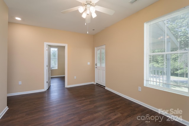 spare room featuring ceiling fan and dark hardwood / wood-style flooring