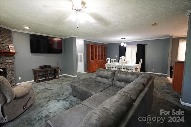 living room with a textured ceiling, dark carpet, crown molding, and a fireplace