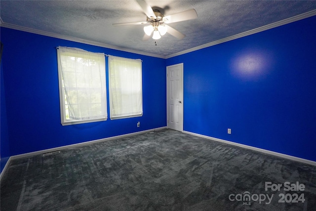 spare room with ceiling fan, carpet flooring, ornamental molding, and a textured ceiling