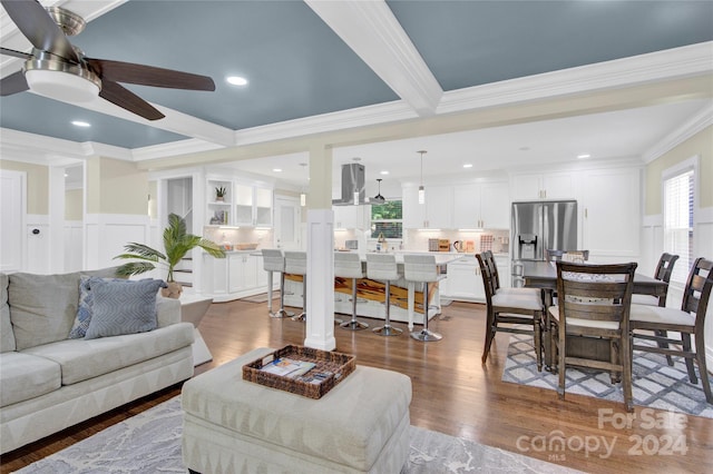 living room featuring crown molding, dark hardwood / wood-style floors, and beamed ceiling