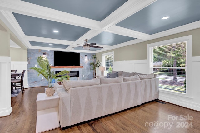 living room with a fireplace, a healthy amount of sunlight, beam ceiling, and coffered ceiling