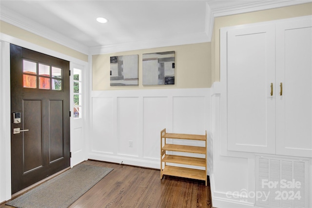 foyer featuring dark wood-type flooring and ornamental molding