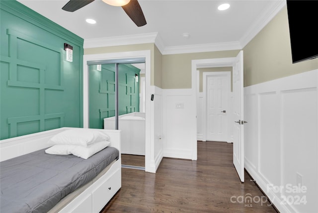 bedroom featuring ceiling fan, ornamental molding, and dark hardwood / wood-style flooring