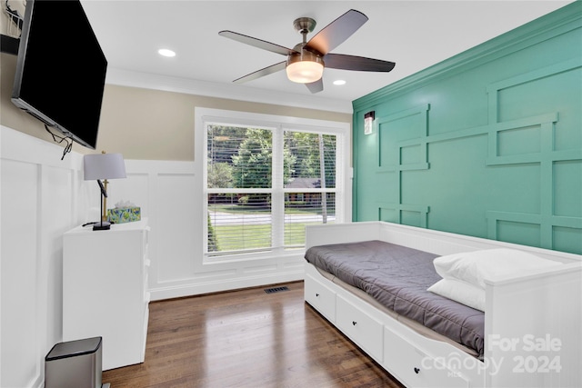 bedroom with ceiling fan, dark wood-type flooring, and ornamental molding