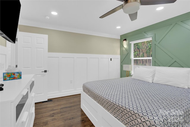 bedroom with ceiling fan, dark wood-type flooring, and crown molding