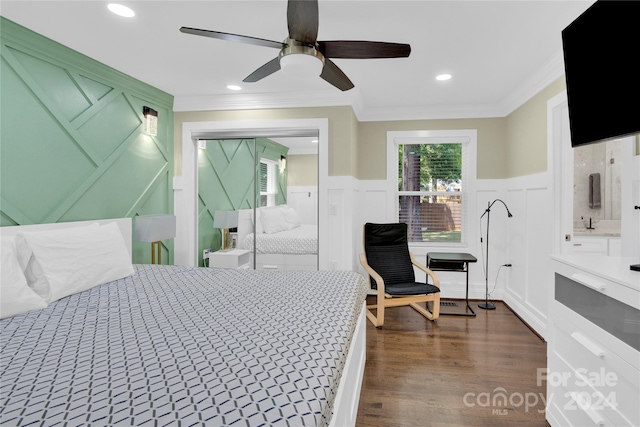 bedroom featuring ceiling fan, dark wood-type flooring, multiple windows, and crown molding