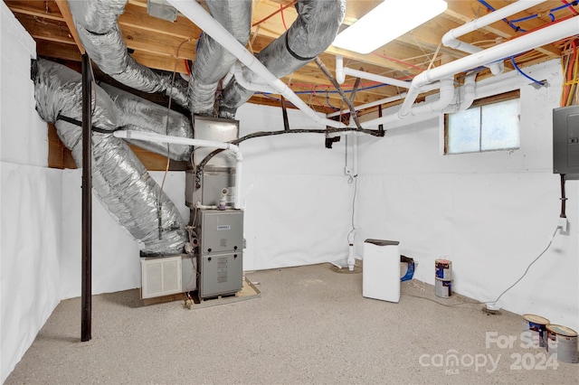 basement featuring heating unit and electric panel