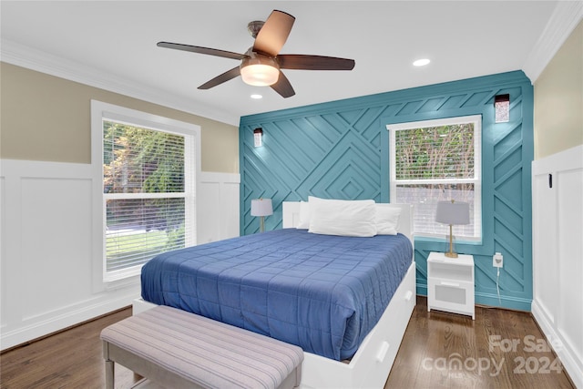 bedroom with dark wood-type flooring, ceiling fan, and ornamental molding