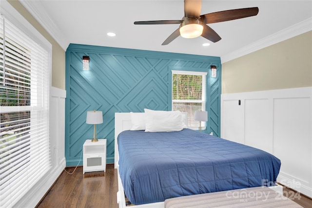 bedroom with dark wood-type flooring, ceiling fan, and crown molding