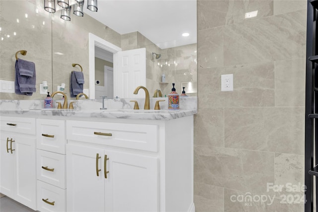 bathroom with a shower and vanity