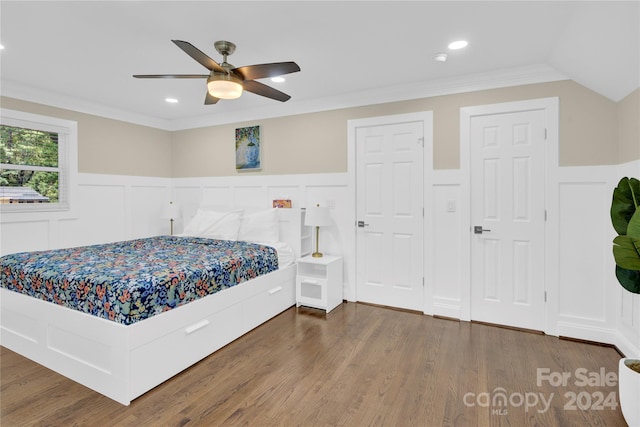 bedroom with ceiling fan, dark hardwood / wood-style floors, and ornamental molding