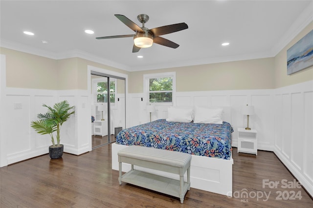 bedroom featuring ceiling fan, dark wood-type flooring, and ornamental molding