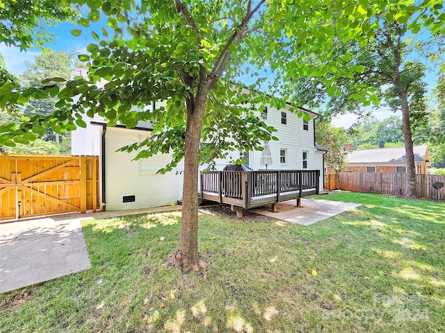 view of yard with a wooden deck and a patio