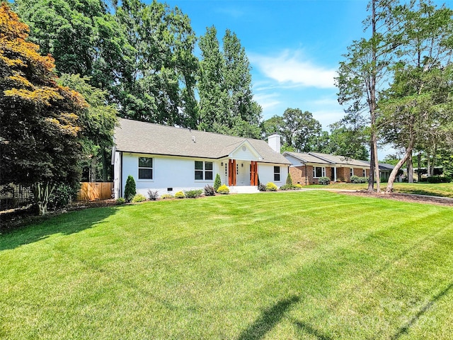 single story home featuring a front lawn