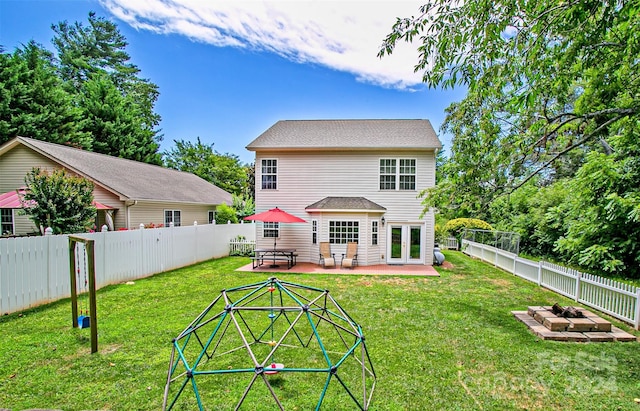 rear view of house featuring french doors, a patio, and a yard