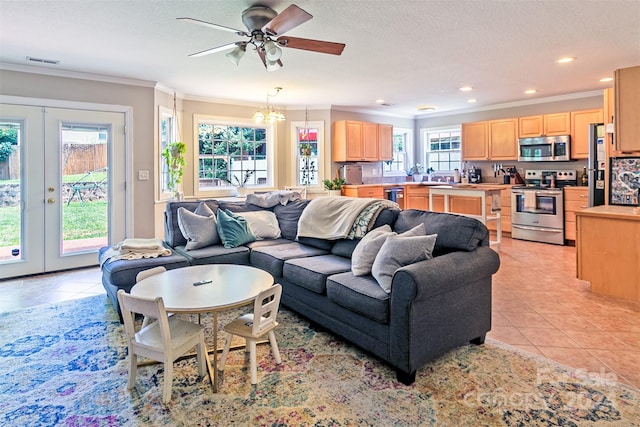 living room with ceiling fan with notable chandelier, ornamental molding, french doors, and light tile patterned flooring