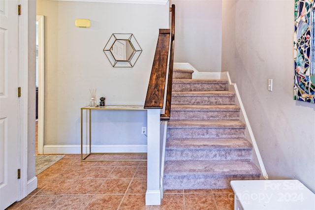 stairway featuring tile patterned flooring